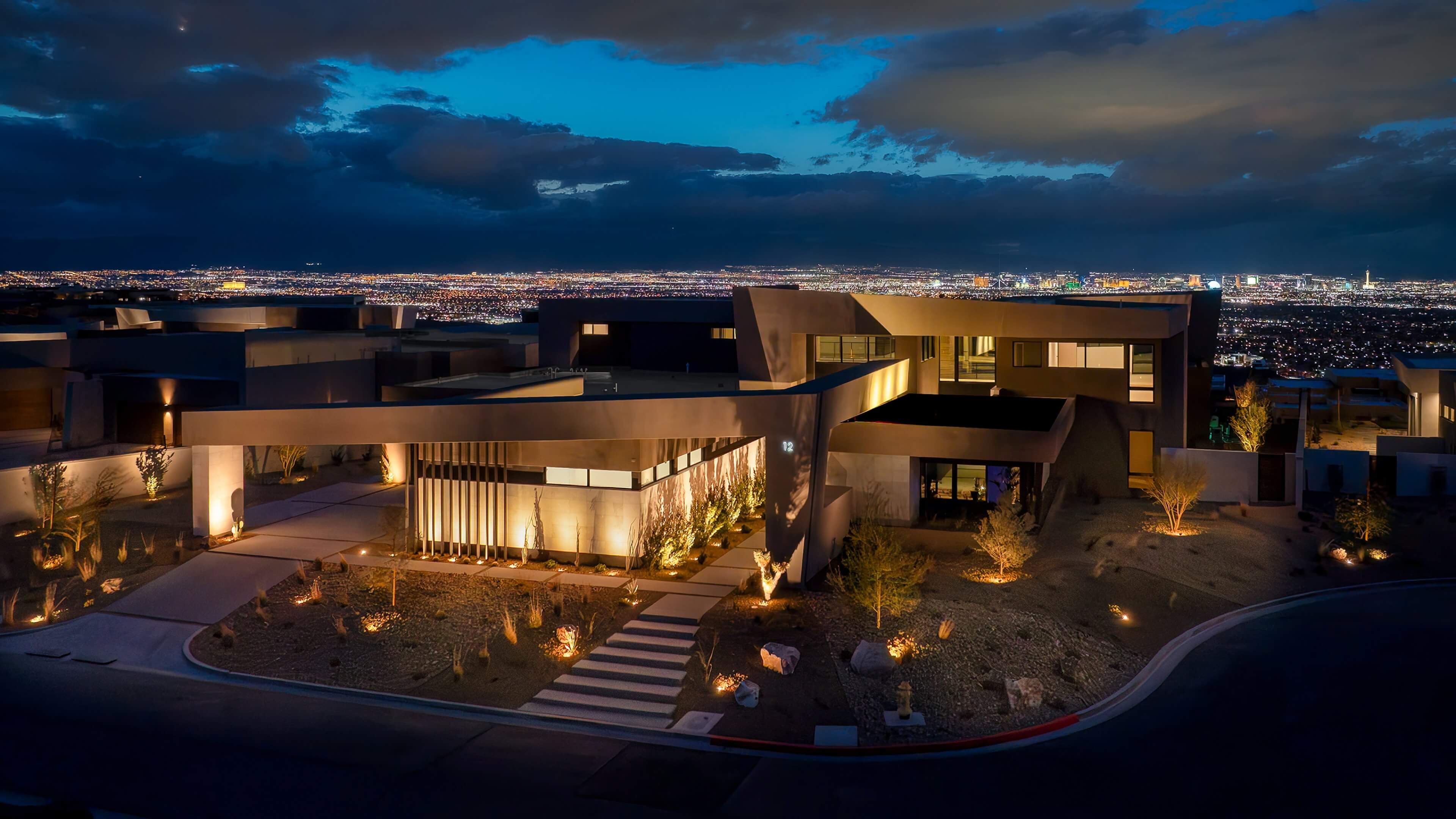 A modern Las Vegas hillside estate at dusk, above the valley lights